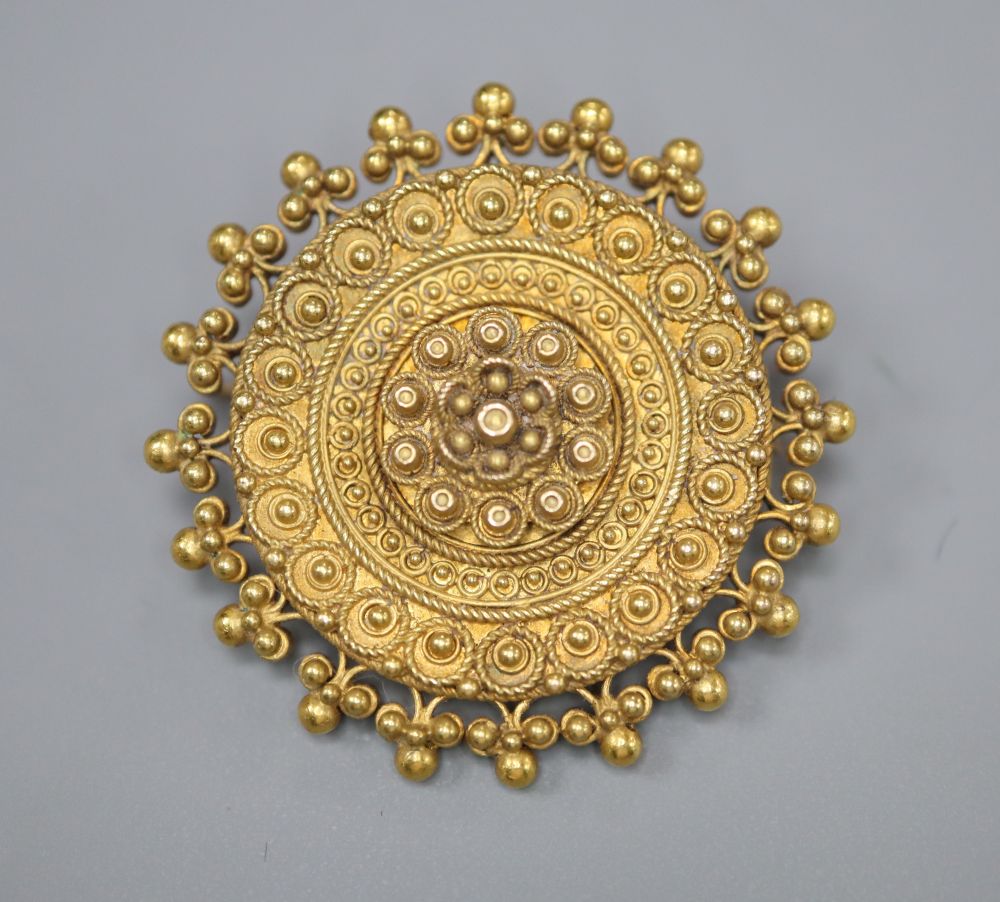 A late Victorian yellow metal circular brooch, with sphere and ropetwist decoration, 28mm, 7.7 grams.